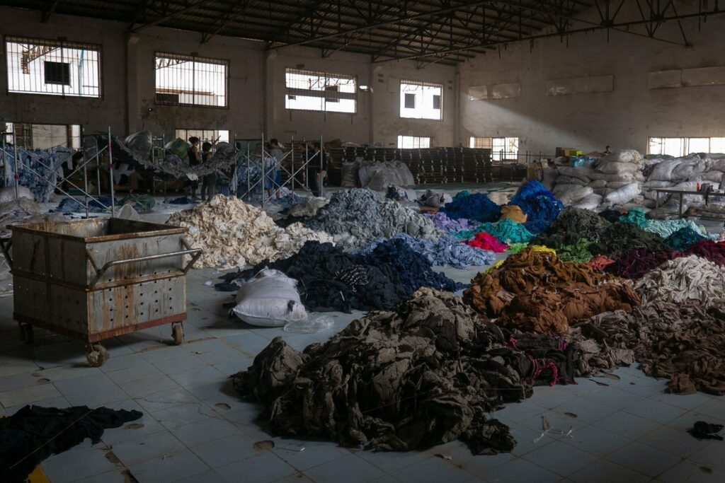 Workers sorting textiles at tables